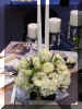 Candle centerpiece of Hydrangea, Roses, Gerbera Daisies and Queen Anne's Lace in a black, square vase